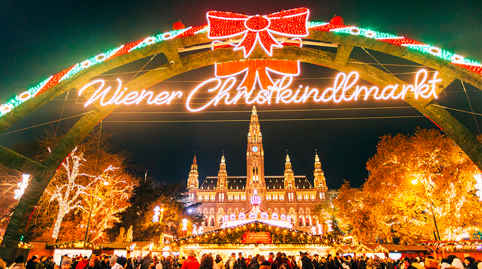 Christmas market with bright Christmas lights by the City Hall in Vienna, Austria
